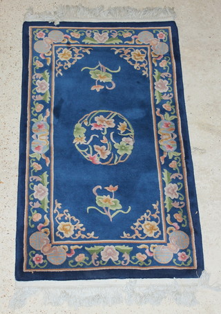 A Chinese blue ground and floral patterned rug 62" x 36" 
