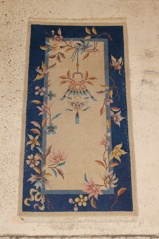 An Indian  blue and white ground rug decorated a lantern to the centre 59" x 31" 
