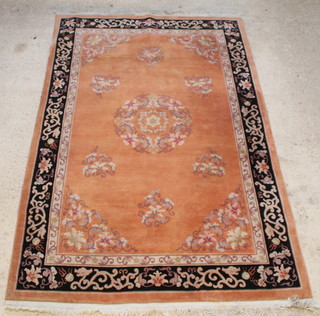 An orange and floral patterned Chinese rug with central medallion, some signs of old moth 112" x 72" 