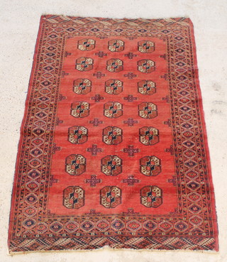 A red ground Bokhara rug with 22 octagons to the centre within a multi-row border, some wear 77" x 50 1/2" 