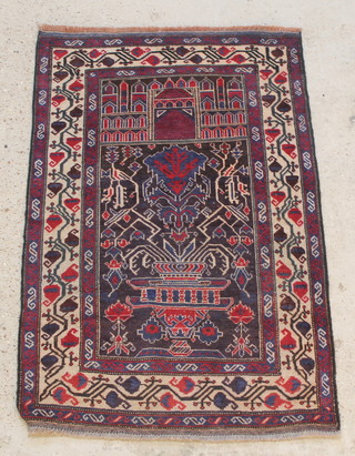 A red and white ground Baluch prayer rug with stylised decoration to the centre 54" x 35" 