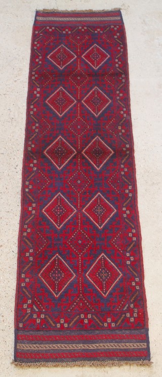 A red and blue ground Meshwani runner with 10 diamonds to the centre 93" x 25" 