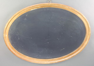 An oval bevelled plate wall mirror contained in a decorative gilt ribbon frame 23"h x 33"w 