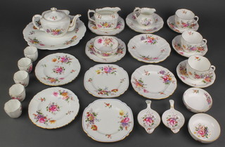 A Royal Crown Derby part tea set comprising teapot, milk jug, cream jug, 3 cups, 3 saucers, 5 small plates, a sandwich plate, a bowl, 5 egg cups, 2 strainers and 2 dishes