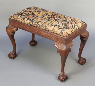 A Georgian Chippendale style carved mahogany rectangular stool with upholstered wool work seat and blind fret work frieze, raised on cabriole, claw and ball supports 19"h x 28"l x 17"w  