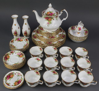 A Royal Albert Country Roses tea and coffee set comprising teapot, 6 tea cups, 6 saucers, 6 coffee cups, 6 saucers, 6 small plates, 6 dinner plates, 6 dessert bowls, 2 vases, a ring stand, 2 dishes