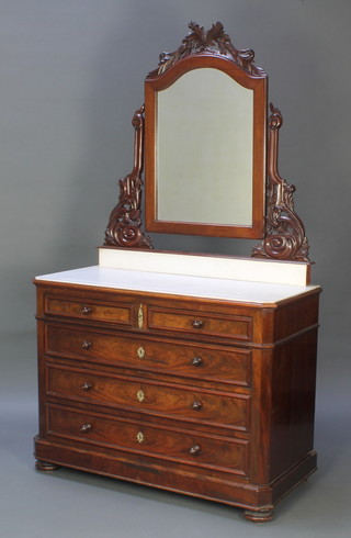A Continental 19th Century mahogany dressing chest with arch shaped mirror surmounted by torches, having a white veined marble top above 2 short and 4 long drawers with tore handles, raised on bun feet 46"w x 21"d 