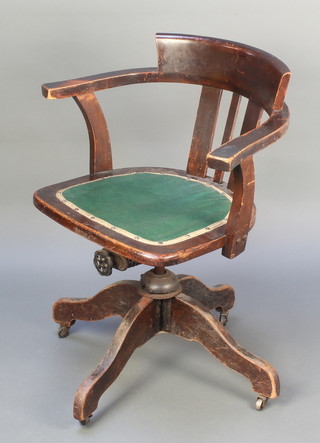 An Edwardian mahogany revolving and adjustable tub back office chair 