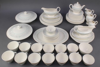 A Royal Doulton Arabesque pattern tea and dinner service comprising 7 tea cups, 12 saucers, a teapot, 3 bowls, 2 milk jugs, 1 cream jug, 2 sauce boats and stands, 12 small plates, 6 medium plates, 5 dinner plates, 6 soup bowls, 3 serving plates, 2 tureens and covers