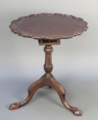 A Georgian style circular mahogany snap top table with pie crust edge and bird cage action, raised on turned column and supports with egg and claw feet 27"h x 22 1/2" diam. 