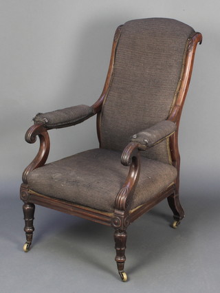 A William IV mahogany show frame open arm chair upholstered in black material, raised on turned and reeded supports 