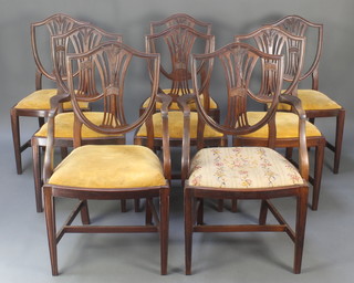 A set of 8 19th Century Hepplewhite style shield back dining chairs with pierced vase shaped slat backs and upholstered seats, raised on square tapering supports with H framed stretcher 