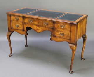 A Queen Anne style crossbanded walnut writing table with inset tooled leather writing surface above 1 long drawer flanked by 2 short drawers, raised on cabriole supports 31"h x 46 1/2"w x 20 1/2d 