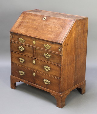 An 18th Century oak bureau, the fall front revealing a fitted interior with well, above 2 short and 2 long drawers 35 1/2"h x 30"w x 18"d 