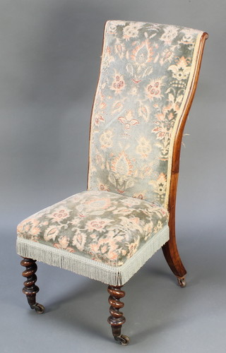 A Victorian rosewood show frame nursing chair upholstered in green sculptured floral dralon, raised on spiral turned supports
