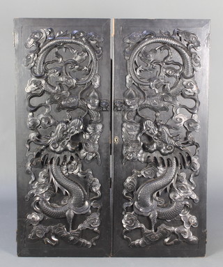 A pair of Chinese ebony carved panelled doors, carved dragons 43"h x 34"w 