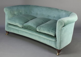 A Victorian crescent shaped Chesterfield style sofa upholstered in blue buttoned material 26"h x 67"w x 30"d 
