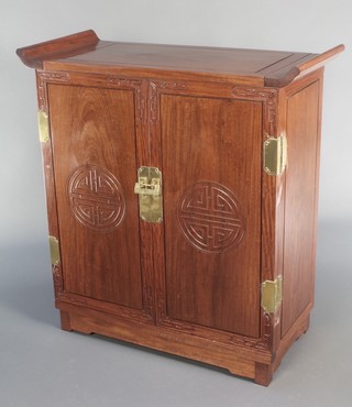 A Chinese carved Padouk cocktail cabinet with hinged lid and well fitted interior enclosed by a pair of panelled doors 40"h x 37"w x 16"d 