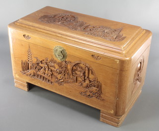 A carved camphor coffer with hinged lid 23"h x 39 1/2"w x 21"d 