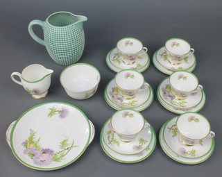 A Royal Doulton Glamis Thistle part tea set decorated by P Curnock comprising 6 tea cups, 6 saucers, 6 sandwich plates, bread plate, a milk jug and sugar bowl together with a  Clarice Cliff green glazed corn on the cob jug 8" 