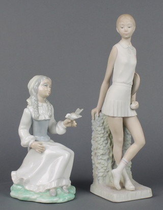 A matt Lladro figure of a lady tennis player 12 1/2" and a Continental figure of a girl with bird 8" 