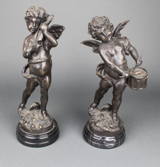 A pair of bronzed figures of a boy drummer and  violinist, raised on black marble socle bases 12" 