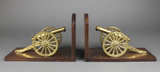 A pair of mahogany and brass book ends decorated canons 6" x 9 1/2" x 4 1/2" 
