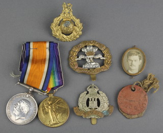 A pair British War medal and Victory medal to 59041 Pte. J F Wright, Cheshire Regt., together with a South Lancashire Regiment cap badge, a Suffolk Regt. cap badge, Royal Marine cap badge, and 2 dog tags 