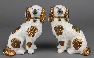 A pair of 19th Century Victorian Staffordshire figures of spaniels with ochre decoration and separated front leg 5 1/2" 