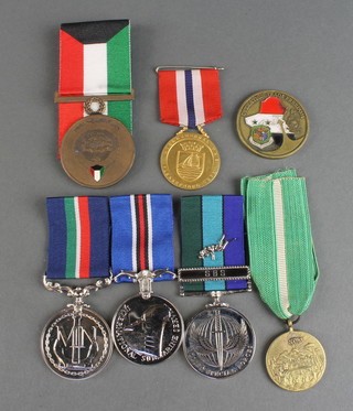 A Kuwaiti Liberation medal 1991, an Operation Iraq  Freedom medallion, a group of 3 commemorative medals to G G Hards Royal/Merchant Navy medal comprising International Submarine Service medal, Allied Special Forces medal, Merchant Navy Medal together with 2 other commemorative medals 
