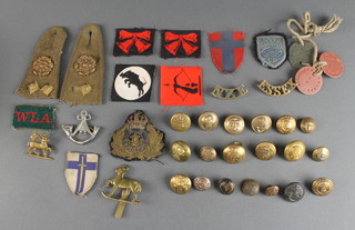 A Royal Naval transport officer's cap badge, various cloth divisional badges, buttons etc 