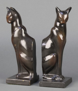 A pair of Art Deco cast metal figures of seated cats 8", raised on square bases 