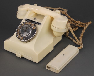 An ivory coloured Bakelite dial telephone, the base marked 312F PL.56/34 