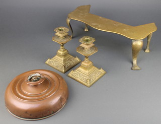 A pair of Victorian square brass candlesticks of squat form with detachable sconces 6" together with a circular copper foot warmer (dented) and a brass footman 