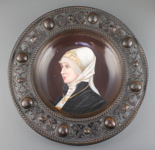 A 19th Century German circular porcelain plaque with painted decoration depicting a classical lady, contained in a pierced bronze frame 11" 