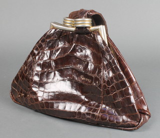 A vintage shaped crocodile handbag with suede interior and metal clasp 8"h x 12"w x 4 1/2"d 