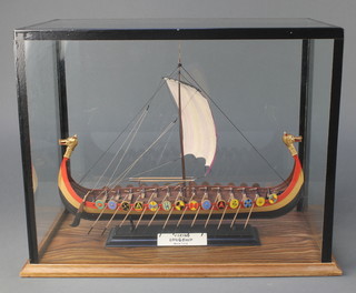 A model of a Viking long ship contained in a glazed case 13" x 16 1/2" x 9 1/2" 