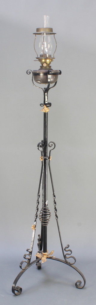 A Victorian wrought iron adjustable oil lamp 