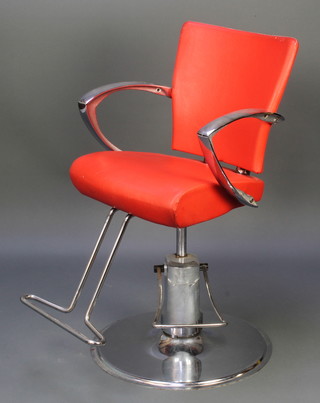 A stylish chromium plated adjustable swivel barbers/dentists chair with red leatherette upholstery