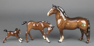 A Beswick figure of a standing horse 7 1/2", 2 Royal Doulton figures of foals 3" and 4" 