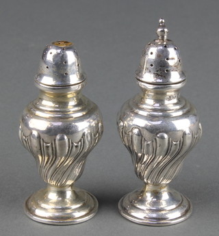 A pair of Edwardian silver repousse condiments Makers Farraday & Davey London 1906 3 1/4" 