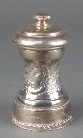 A repousse silver pepper mill with scroll decoration Birmingham 1973 