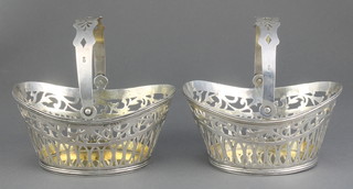 A pair of Dutch silver pierced baskets with swing handles, import marks London 1898 210 grams, 4" 
