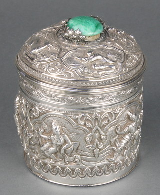 An Indian repousse silver circular box decorated with deities, the lid with a hardstone knop 4 1/2" 
