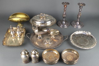 A silver plated entree dish, a pair of plated candlesticks and minor plated items 