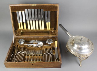 A silver plated breakfast warmer with ebony handle, stand and burner together with a cased canteen of plated cutlery for 6 