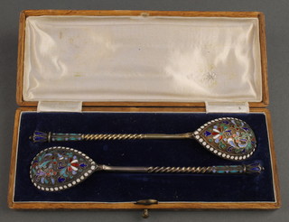 A pair of late 19th Century Russian silver and enamelled spoons floral decoration contained in a fitted case 47 grams