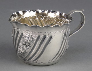 A Victorian repousse silver cream jug with floral decoration Maker Charles Edwards London 1888 94 grams