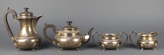 A silver 4 piece tea set with beaded decoration on pad feet ebony mounts Maker Robert Chandler Birmingham 1947, gross 1456 grams 
