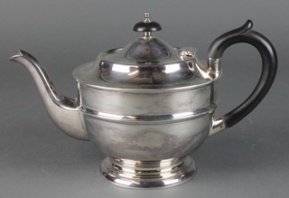 A silver teapot with ebony mounts, Maker Viners Sheffield 1933, gross 465 grams 